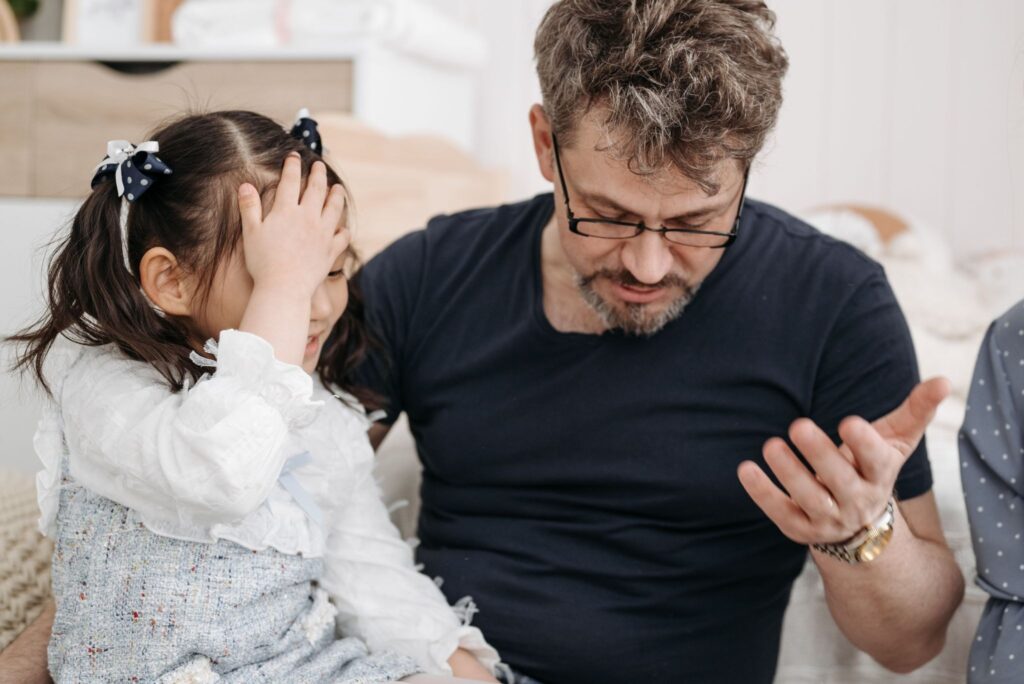 Father talking with his young daughter to support her speech development