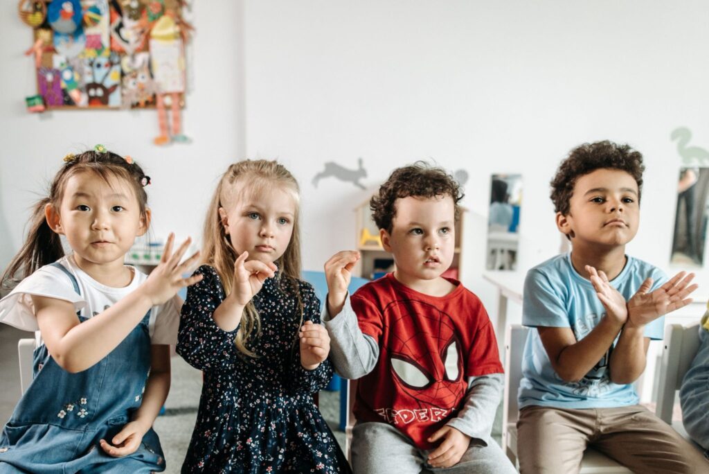 Group of toddlers showing gestures and expressions related to speech development
