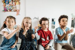 Group of toddlers showing gestures and expressions related to speech development