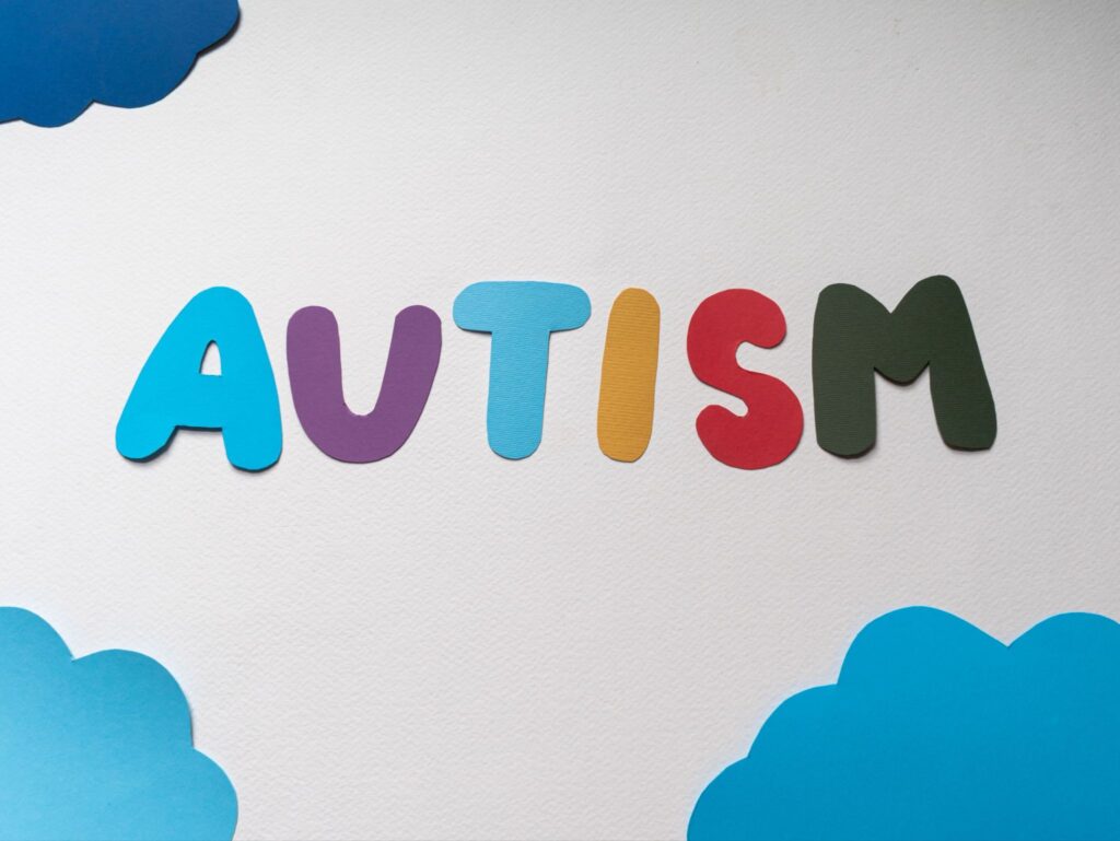 Colorful AUTISM letter craft with paper clouds, autism awareness banner