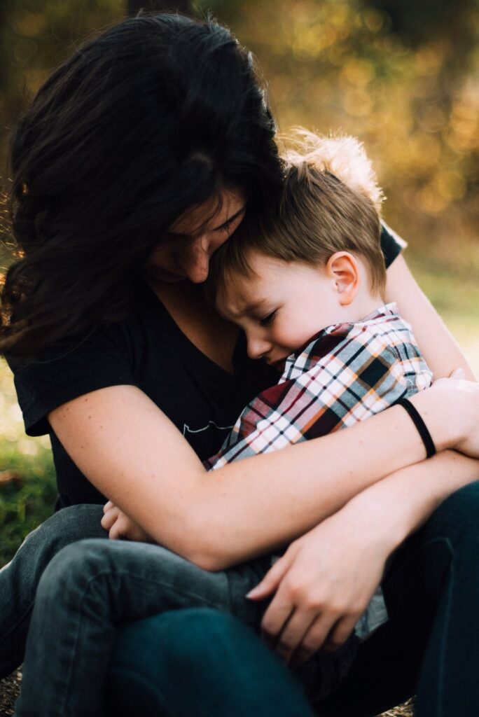Mother comforting a distressed toddler, emotional support for children with autism